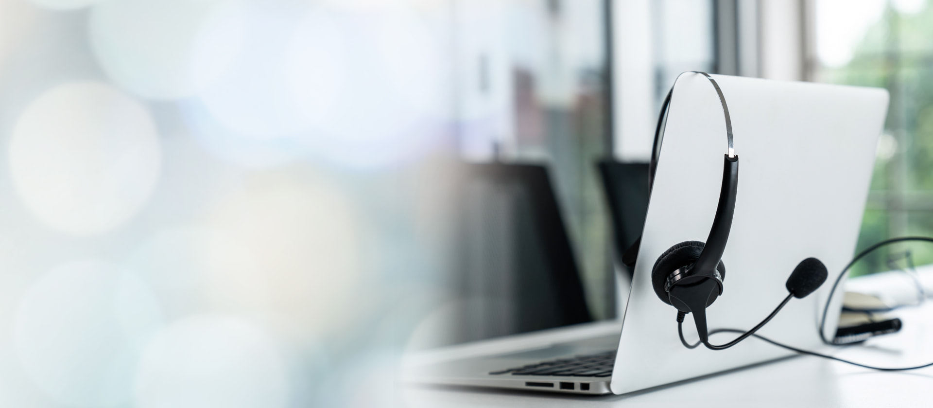 Technical support specialist with headset working at dual monitors